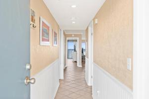 a hallway of a home with a door open at Pelican Watch #307 in Carolina Beach