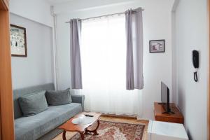 a living room with a couch and a tv at Hotel Holiday in Victoria