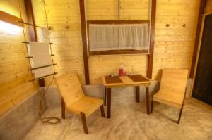 a room with a table and chairs in a cabin at Beverly Hill Cabanas Hikkaduwa in Hikkaduwa