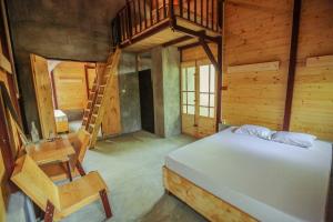 a bedroom with a bed and a wooden house at Beverly Hill Cabanas Hikkaduwa in Hikkaduwa +15 photos