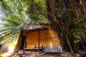 a small brick building with a table and a tree at Beverly Hill Cabanas Hikkaduwa in Hikkaduwa
