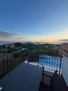 a balcony with a table and a swimming pool at Dela in Hvar +37 photos