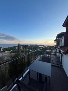 a balcony with a bench and a view of the ocean at Dela in Hvar