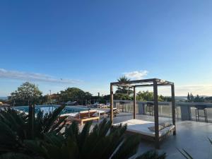 a rooftop patio with a gazebo and a pool at Dela in Hvar