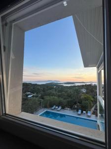 a view of a swimming pool from a window at Dela in Hvar