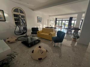 a living room with a couch and chairs and a table at Dela in Hvar
