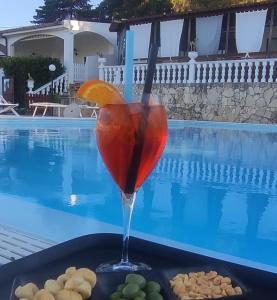 a drink sitting on a tray next to a pool at Althea Village Residence in Vieste