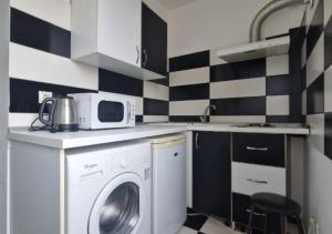 a kitchen with a washing machine and a microwave at StudioApartment LUXOR in Constanţa +53 photos