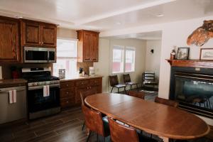 a kitchen with a wooden table and a dining room at The Long Barn Lodge in Long Barn