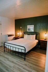 a bedroom with a large bed with a green wall at The Long Barn Lodge in Long Barn +91 photos