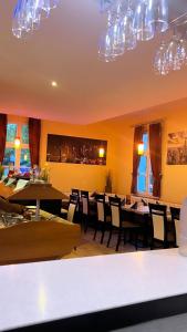 a dining room with tables and chairs and chandeliers at Hotel Deutsches Haus und Restaurant Olympia in Magdeburg +16 photos