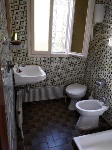 a bathroom with a sink and a toilet and a window at The Lemon House by The Sea in Áyioi Apóstoloi