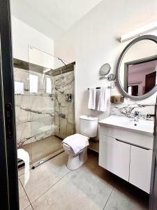 a bathroom with a shower and a toilet and a sink at Royal Goddess Guest House, Walled City in Mağusa