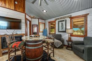 a living room with a table and chairs and a tv at Rockin' R - Morning Star Cabin in Fredericksburg
