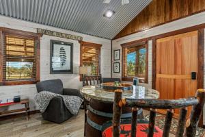 a living room with a table and a chair at Rockin' R - Morning Star Cabin in Fredericksburg