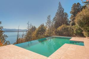 a swimming pool with a view of the water at A3- Departamento con Vista Panorámica y Piscina in San Carlos de Bariloche