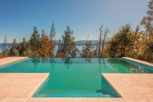 a swimming pool with a view of the water at A3- Departamento con Vista Panorámica y Piscina in San Carlos de Bariloche