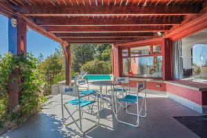 a patio with a table and chairs and a pool at A3- Departamento con Vista Panorámica y Piscina in San Carlos de Bariloche