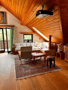 a living room with a couch and a table at Großzügiges Landhaus im Grünen in Oberpiesting