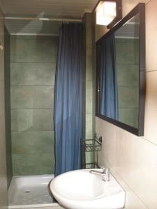 a bathroom with a sink and a mirror and a tub at Ośrodek Szeligi in Ełk +68 photos