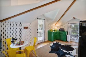a kitchen with a table and some yellow chairs at Stonewall Bungalow 4 - Sleeps 3 in Stonewall