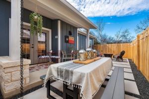 a patio with a table and chairs and a fence at Strawberry Suite - Fire Pit BBQ Grill & more in Fredericksburg
