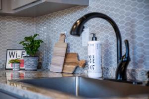 a kitchen counter with a sink and a faucet at Strawberry Suite - Fire Pit BBQ Grill & more in Fredericksburg +32 photos