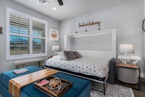 a bedroom with a bed and a table at Strawberry Suite - Fire Pit BBQ Grill & more in Fredericksburg