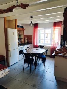 OllierguesCharmant studio tout équipé的房间里有一张桌子和几把椅子的厨房