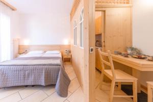 Ένα ή περισσότερα κρεβάτια σε δωμάτιο στο Comano Vacanze Appartamenti