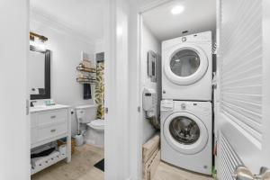 a laundry room with a washer and dryer in it at 4 Loungers 2 Umbrellas Inlc Peak Season Beachfront in Panama City Beach
