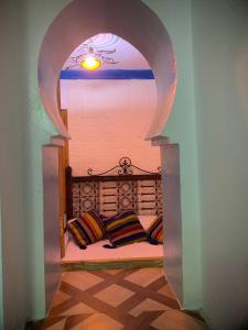 a room with a bed with two pillows on it at Blue heart in Chefchaouene