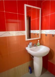 a bathroom with a sink and a mirror at Amazing home stays in Dar es Salaam