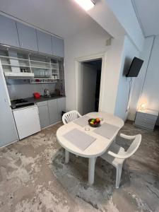 a kitchen with a white table and chairs in a room at Villa Katia in Asprovalta +46 photos