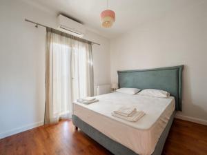 a bedroom with a bed with white sheets and a window at Villa Althea 1 in Kompítsion +82 photos