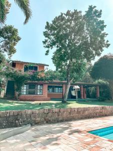 a house with a tree in front of it at A vista mais linda de Ubatuba - Acomoda 20 pessoas in Ubatuba