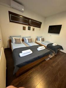 a room with two beds and a flat screen tv at Casa Lila in Sarajevo
