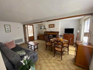 a living room with a couch and a table at La Halte de la Hunière in Vimoutiers +16 photos