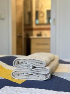 a pile of towels sitting on top of a bed at Casa Lila in Sarajevo