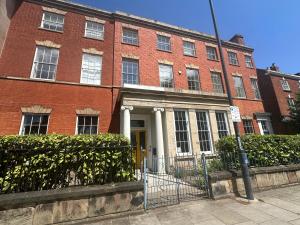 a red brick building with a yellow door at Friar Gate House - Grand Georgian Townhouse in Derby Centre in Derby