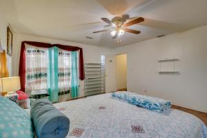 a bedroom with a bed and a ceiling fan at Charming McAllen Rental Home with Private Backyard! in McAllen