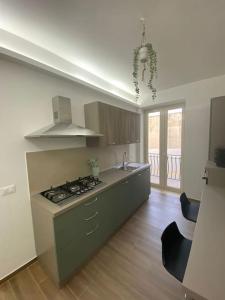 a kitchen with a stove and a counter top at Goodluck casa vacanza Avola in Avola
