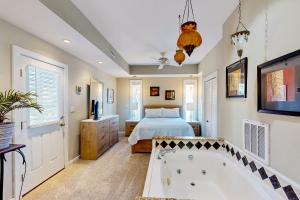a bedroom with a bed and a bath tub at Breakwater #75-HC in Avon +24 photos