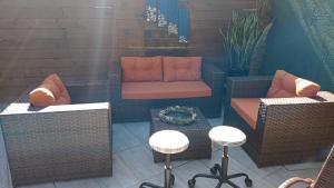 a patio with two chairs and a couch and a table at Pousada ZAUA GUEST HOUSE in Florian&oacute;polis