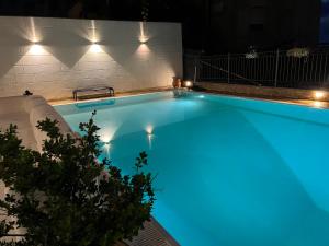 a swimming pool at night with blue lighting at Kairos Tropea in Tropea