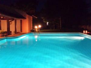 a large swimming pool at night with lights on it at Modern Villa in Caltagirone Italy with Pool in Caltagirone