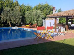 a couple of chairs sitting next to a swimming pool at Modern Villa in Caltagirone Italy with Pool in Caltagirone