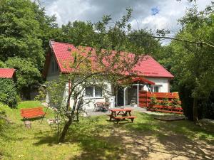 stół piknikowy i ławka przed domem w obiekcie Apartament Zacisze w mieście Świecino