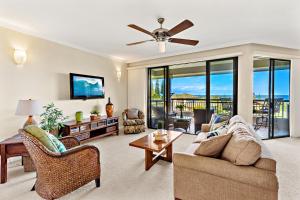 a living room with a couch and a ceiling fan at Kapalua Golf Villa 20V 1 in Kahana