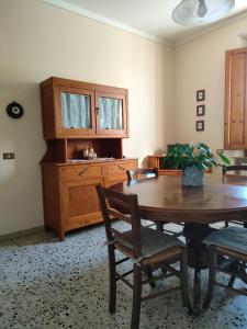 a dining room with a wooden table and chairs at Podere Gian Battaglia in Fucecchio